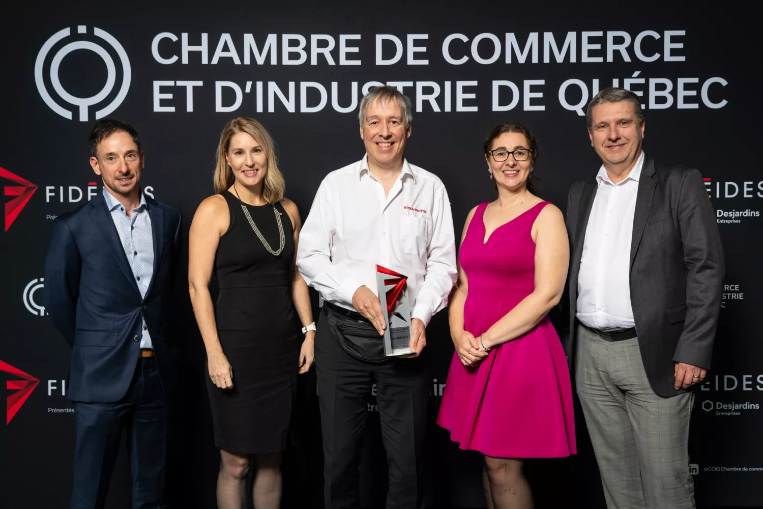 The delegation from InnovMetric on stage, proudly receiving a third and unexpected prize, "Prix Rayonnement Hors Québec"!